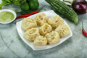 Nepali steamed dumplings  Momo with sause photo