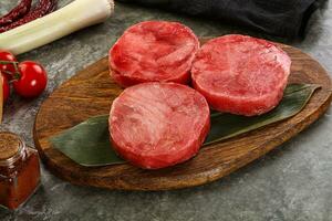 Delicous raw tuna medallion for cooking photo