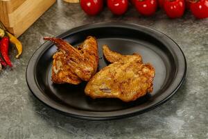 Tasty roasted chicken wing with spices photo