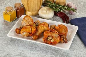 Raw marinated chicken drumstick for cooking photo