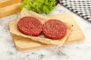 Raw beef  burger cutlet for grill photo