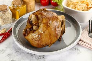 Baked pork knee with spices photo