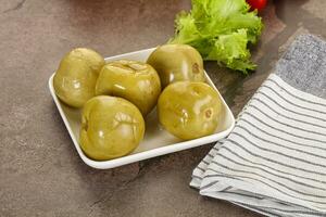 Homemade pickled green tomato appetizer photo