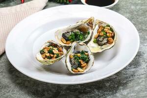 Open half oysters with green onion photo
