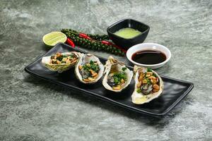 Open half oysters with green onion photo