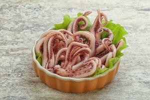 Marinated squid tentacles in the bowl photo