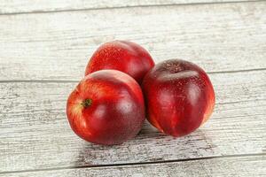 Ripe sweet juicy nectarines heap photo