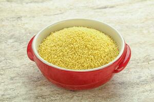 Raw couscous in the bowl photo