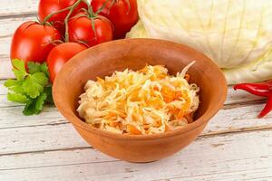 Fermented cabbage sauerkraut in the bowl photo