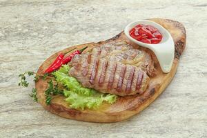 Grilled pork neck steak with ketchup photo