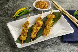 Thai meat skewer Satay with sauce photo