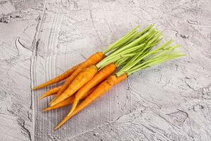 Young raw carrot heap isolated photo