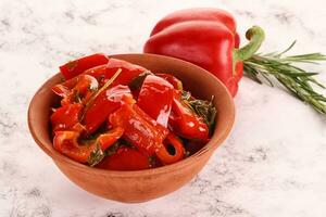 Pickled red bell pepper in the bowl photo