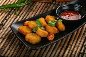 Crispy golden choclen nuggets with sauce photo