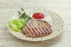 Grilled pork neck steak with ketchup photo