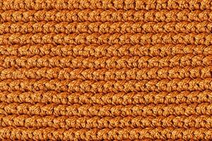 Orange knitted fabric texture background. Top view. Copy, empty space for text photo