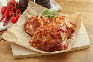 Marinated chicken leg in tomato sauce photo