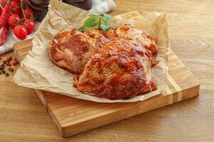 Marinated chicken leg in tomato sauce photo