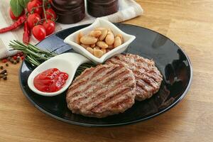 Grilled beef burger cutlet with sauce photo