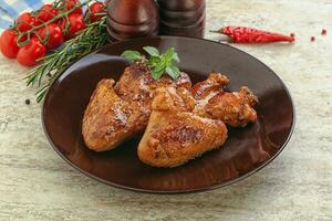 Roasted chicken wings with spicy sauce photo