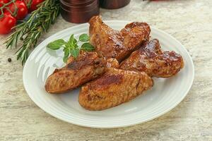 Roasted chicken wings with spicy sauce photo