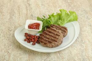 Grilled beef burger cutlet with sauce photo