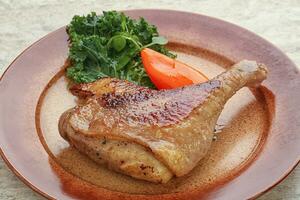 Roasted duck leg with orange sauce photo