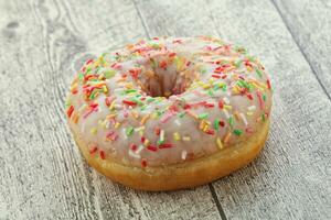 Sweet glazed vanilla donut with icing photo