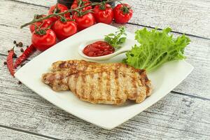 Grilled pork steak with ketchup photo