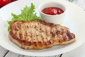 Grilled pork steak with ketchup photo