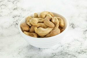 Cashew nuts heap in the bowl photo