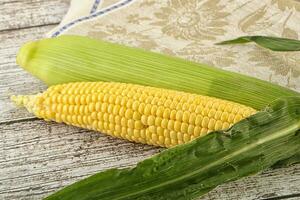 Yellow sweet raw cob corn photo