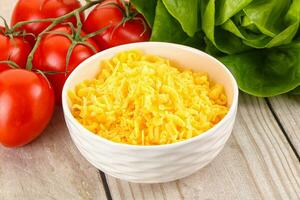 Shredded cheese in the bowl photo