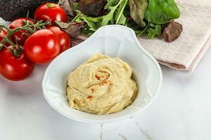 Creamy hummus in the bowl photo