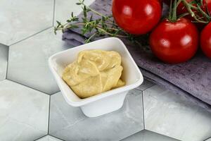 Dijon mustard sauce in the bowl photo
