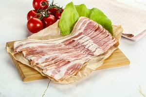 Sliced pork bacon oved board photo