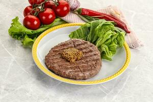 Frilled beef burger cutlet with iceberg photo