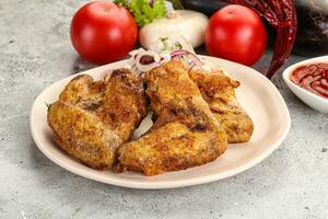 Grilled chicken wings with sauce photo