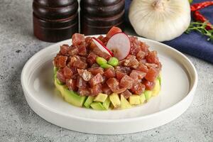 Tuna tartar with avocado and sauce photo