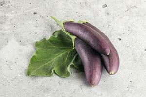 Raw ripe organic eggplant with leaf photo