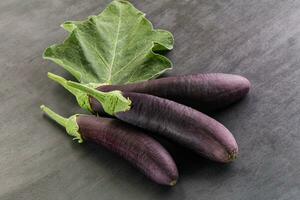 Raw ripe organic eggplant with leaf photo