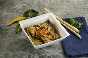 Thai green curry soup with basil photo