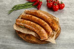 Raw sausages with spices and herbs photo