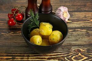 Boiled potato with oil and dill photo