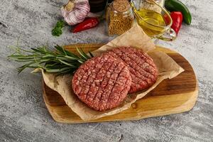 Raw burger cutlet for grill photo