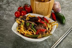 Asian wok with noodle, vegetables and beef photo