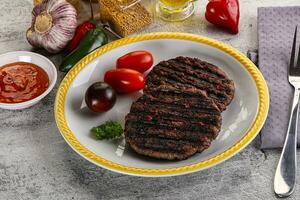 Grilled burger cutlet with sauce photo