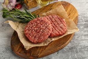 Raw burger cutlet for grill photo