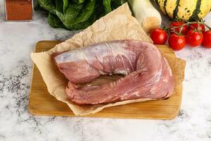 Uncooked raw pork tenderloin with spices photo