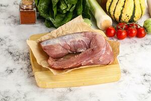 Uncooked raw pork tenderloin with spices photo